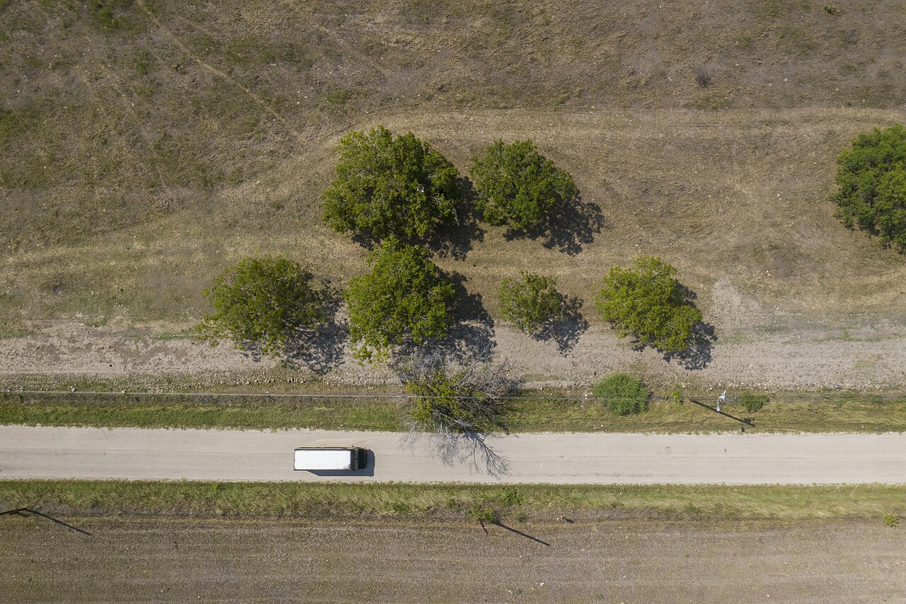 A delivery driver carrying a food box to a home