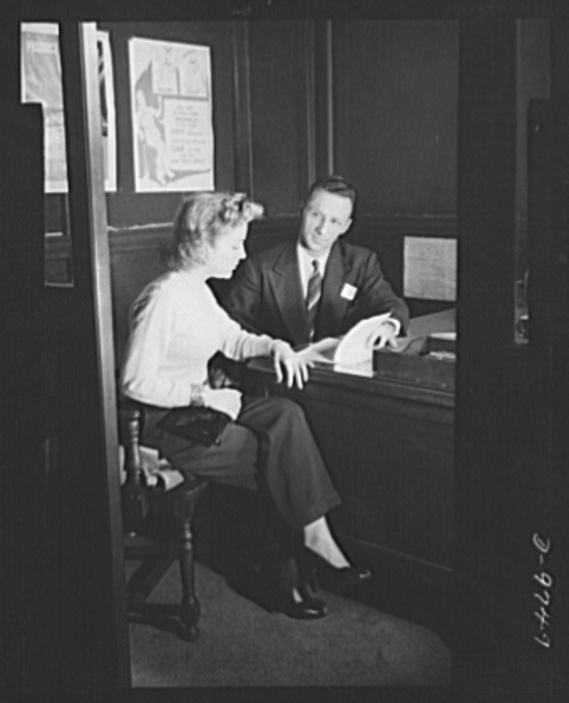 An employment manager interviewing a job applicant at a desk in 1943